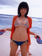 Alluring asian beauty with large full heavy breasts in a bikini